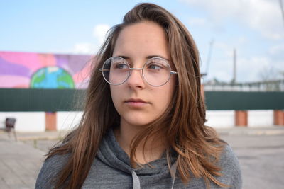 Woman with brown hair looking away 