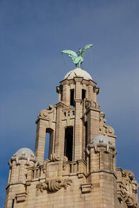 Low angle view of statue against building