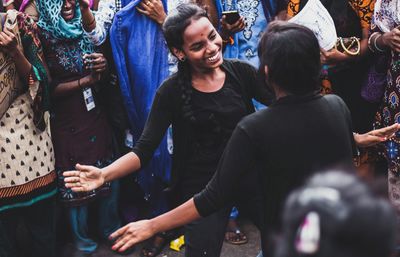 High angle view of smiling women performing on street