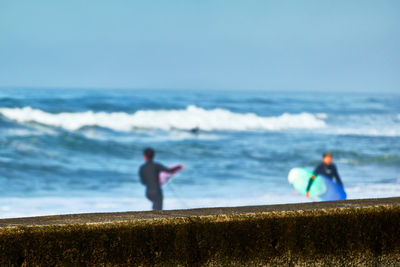 People on beach against sky