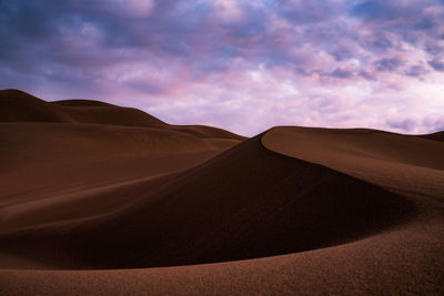 Scenic view of desert against sky during sunset in great sand dunes national park - colorado
