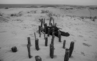 High angle view of wooden posts on beach