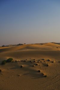 Scenic view of desert against sky during sunset