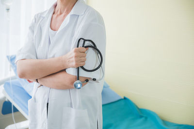 Midsection of woman wearing hat