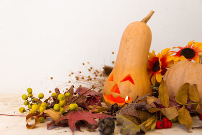 Close-up of fruits and leaves on table