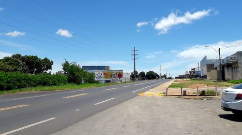 Road by city against sky