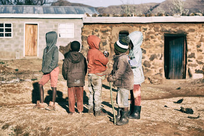 Full length of people standing outside house