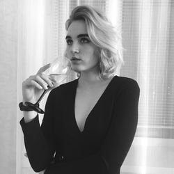 Portrait of a beautiful young woman drinking glass