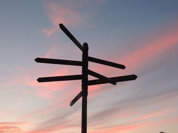 Low angle view of silhouette pole against sky during sunset