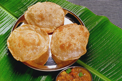 Close-up of bread and leaves on table