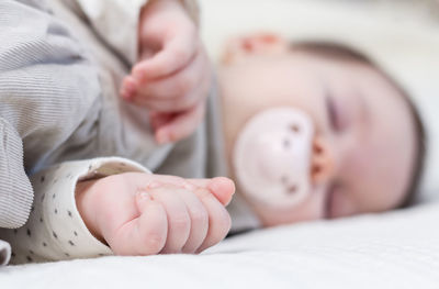 Close-up of baby sleeping on bed
