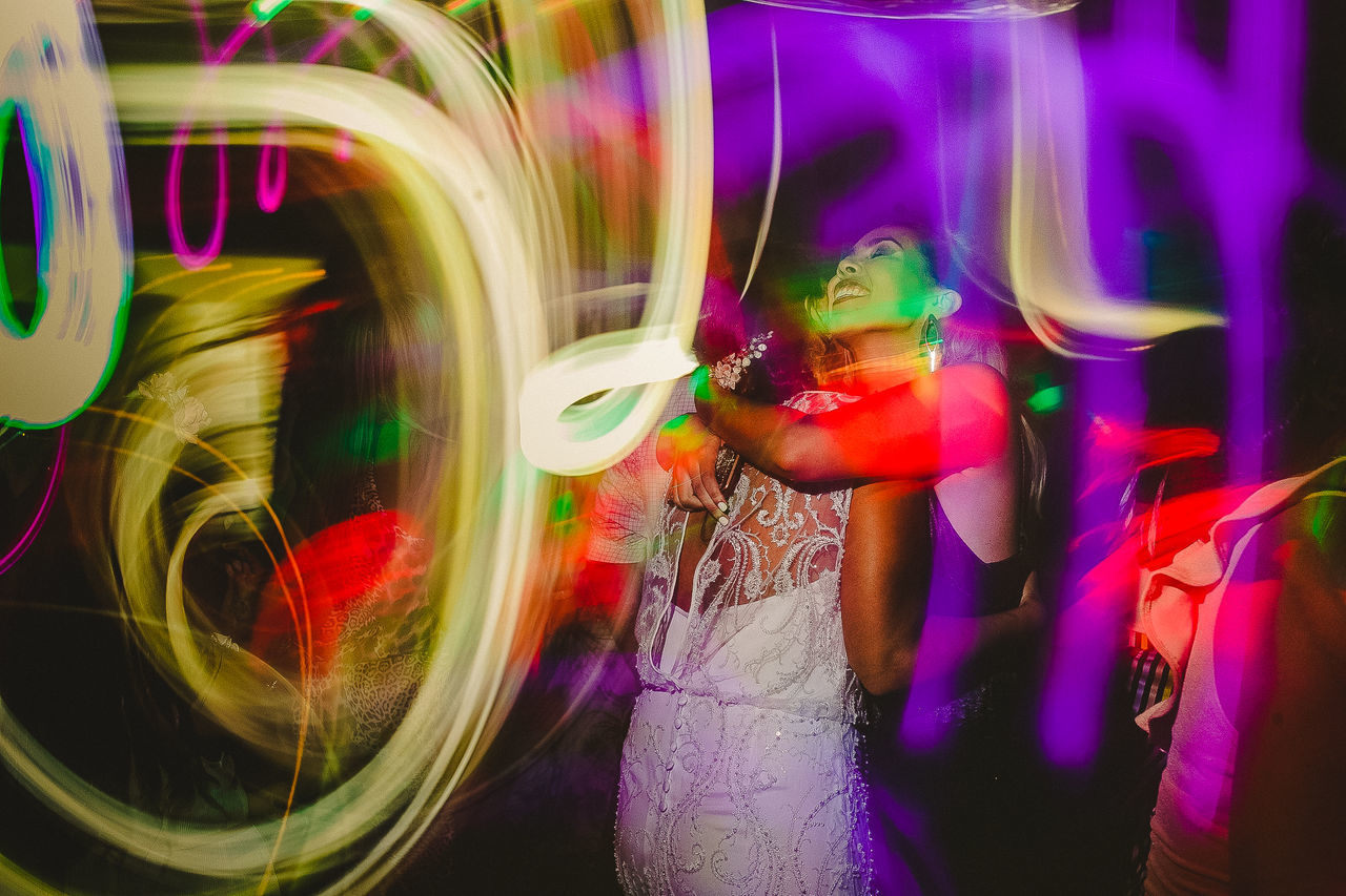 DIGITAL COMPOSITE IMAGE OF WOMAN WITH ILLUMINATED LIGHT PAINTING