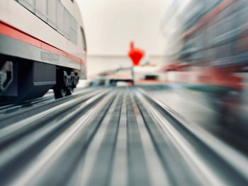 Blurred motion of train at railroad station in city