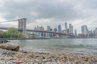 View of bridge over river against cloudy sky