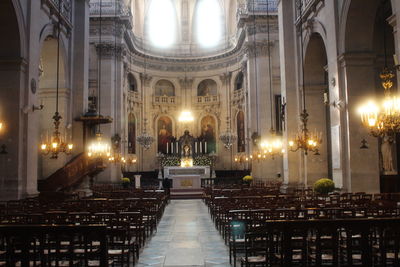 Illuminated chandelier hanging in church