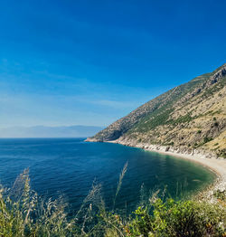 Scenic view of sea against blue sky