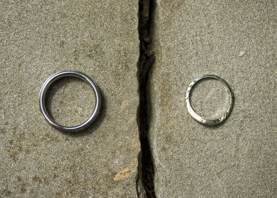 High angle view of wedding rings on metal surface