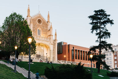 Illuminated trees and buildings against sky