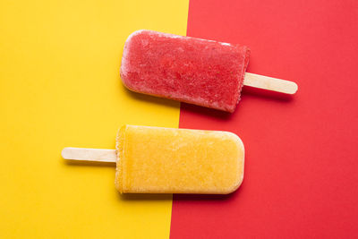 Close-up of ice cream cone against multi colored background