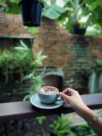 Hand holding coffee cup