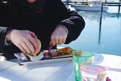 Midsection of man preparing food in restaurant