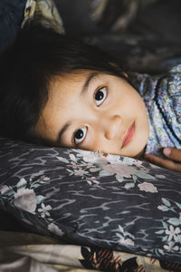 Cute girl relaxing on bed at home