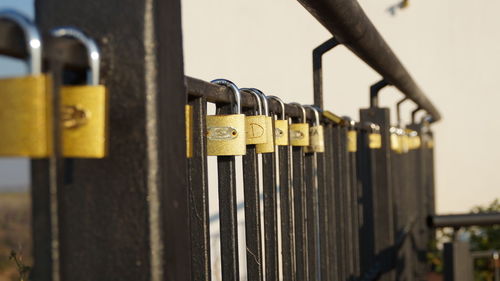 Close-up of padlocks on railing