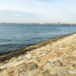 View of calm sea against cloudy sky