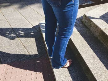 Low section of woman standing on tiled floor