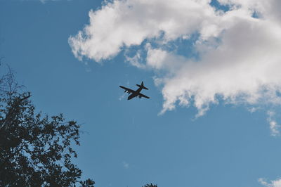 Low angle view of airplane flying in sky