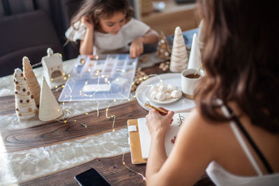 High angle view of woman sitting on table