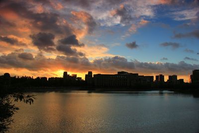 Scenic shot of river with buildings in background