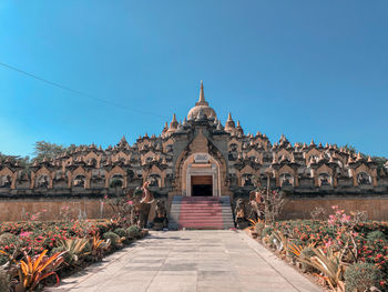 View of temple against clear blue sky