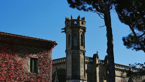 Low angle view of clock tower against blue sky