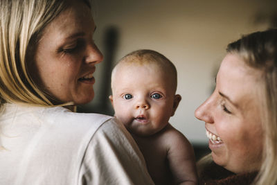 Smiling mother holding newborn baby