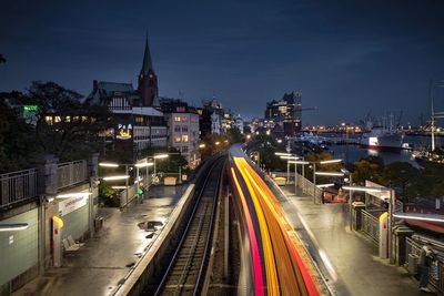 Light trails on illuminated railroad station at night