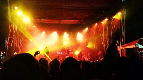 People enjoying music concert at night