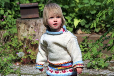 Portrait of girl standing against tree