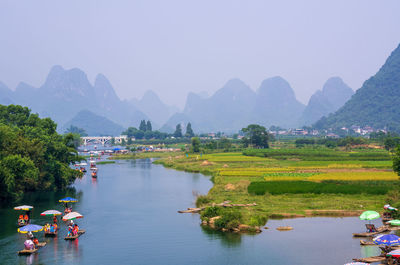 Scenic view of river and mountains against clear sky