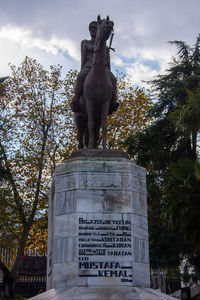 Low angle view of statue against trees