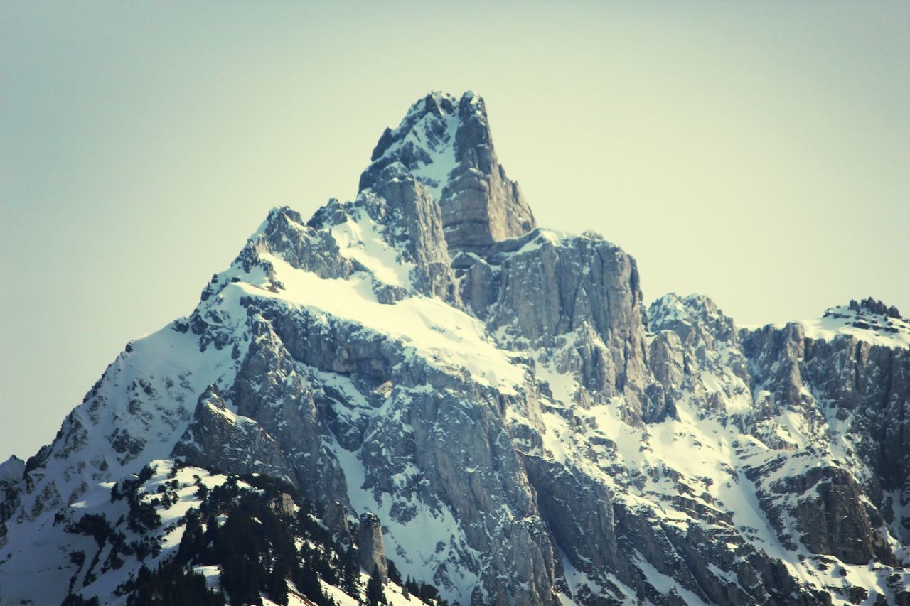 snow, cold temperature, mountain, winter, tranquility, tranquil scene, scenics, clear sky, beauty in nature, mountain range, season, nature, weather, snowcapped mountain, low angle view, non-urban scene, landscape, geology, rocky mountains, sky