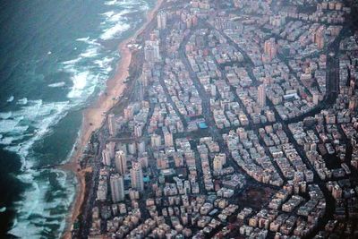 Aerial view of cityscape by sea