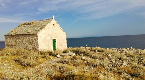 Old church by sea against sky at razanj