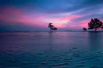 Scenic view of water and pink sky at dusk