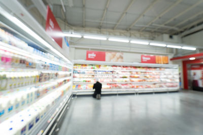 Full length of man standing in illuminated store