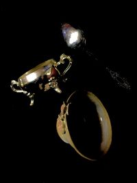 Low angle view of illuminated lights against black background