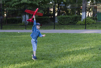 Full length of boy playing on field