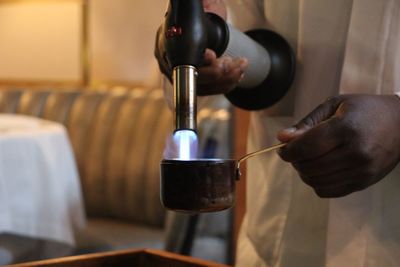 Midsection of man having coffee