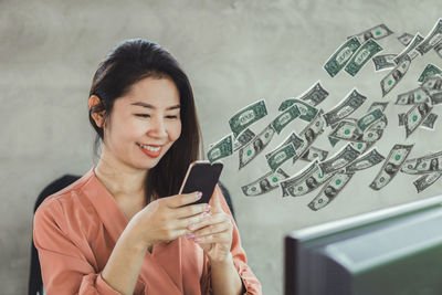 Smiling young man using mobile phone