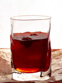 Close-up of drink on table against white background